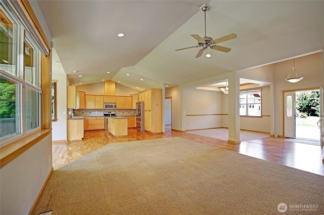 26306 2nd Ave NE, Arlington, WA 98223 - kitchen with appliances with stainless steel finishes, light brown cabinets, vaulted ceiling, open floor plan, and ceiling fan
