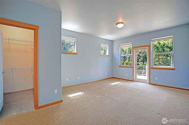 26306 2nd Ave NE, Arlington, WA 98223 - unfurnished bedroom featuring a spacious closet, carpet flooring, access to exterior, and a closet