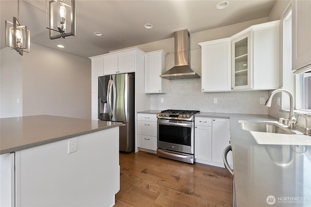 711 Blackstone Ln, Bellingham, WA 98226 - kitchen featuring appliances with stainless steel finishes, a sink, wall chimney range hood, dark wood finished floors, and white cabinets