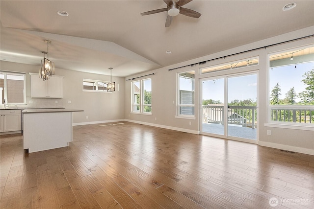 711 Blackstone Ln, Bellingham, WA 98226 - unfurnished living room with ceiling fan, baseboards, vaulted ceiling, wood finished floors, and recessed lighting