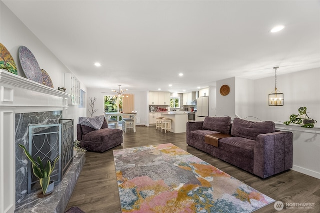 24028 6th Pl W, Bothell, WA 98021 - living area featuring a chandelier, recessed lighting, a premium fireplace, dark wood-type flooring, and baseboards