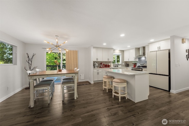 24028 6th Pl W, Bothell, WA 98021 - kitchen featuring wall chimney exhaust hood, stainless steel electric range, freestanding refrigerator, a kitchen island, and white cabinets