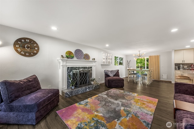 24028 6th Pl W, Bothell, WA 98021 - living room featuring a chandelier, recessed lighting, dark wood-type flooring, a fireplace, and baseboards