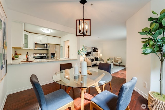 14251 73rd Ave NE Unit A101, Kirkland, WA 98034 - dining space with a chandelier and dark wood finished floors