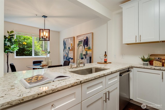 14251 73rd Ave NE Unit A101, Kirkland, WA 98034 - kitchen featuring stainless steel dishwasher, light stone counters, white cabinets, hanging light fixtures, and a chandelier