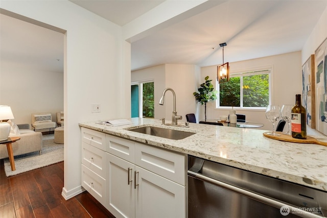 14251 73rd Ave NE Unit A101, Kirkland, WA 98034 - kitchen featuring stainless steel dishwasher, light stone counters, dark wood-style floors, white cabinets, and hanging light fixtures