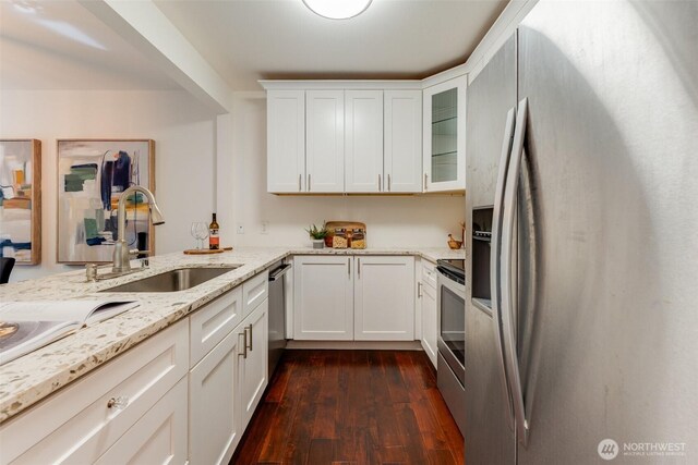 14251 73rd Ave NE Unit A101, Kirkland, WA 98034 - kitchen with stainless steel appliances, dark wood finished floors, white cabinets, light stone counters, and glass insert cabinets