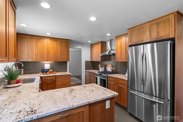 1484 SW Snively Ave, Chehalis, WA 98532 - kitchen featuring appliances with stainless steel finishes, wall chimney range hood, a sink, a peninsula, and decorative backsplash