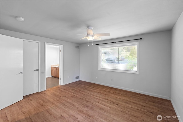 1484 SW Snively Ave, Chehalis, WA 98532 - unfurnished bedroom with light wood-style flooring, ensuite bath, and baseboards