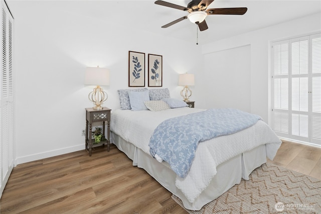 505 Belmont Ave E Unit 704, Seattle, WA 98102 - bedroom with light wood-style floors, a closet, multiple windows, and ceiling fan