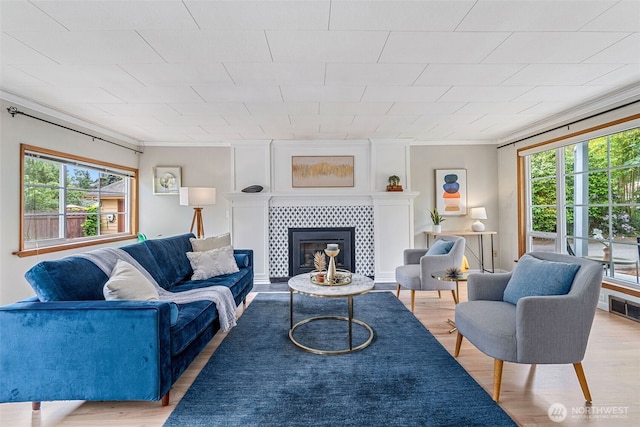 13720 Corliss Ave N, Seattle, WA 98133 - living area with healthy amount of natural light, wood finished floors, ornamental molding, and a fireplace