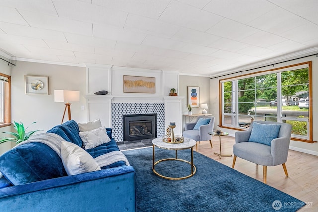 13720 Corliss Ave N, Seattle, WA 98133 - living area with ornamental molding, wood finished floors, and a tiled fireplace