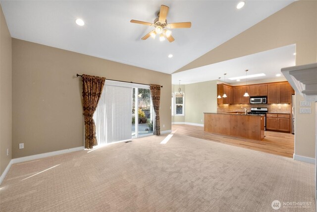 8148 Quinault Rd, Blaine, WA 98230 - unfurnished living room featuring recessed lighting, light colored carpet, baseboards, ceiling fan, and high vaulted ceiling