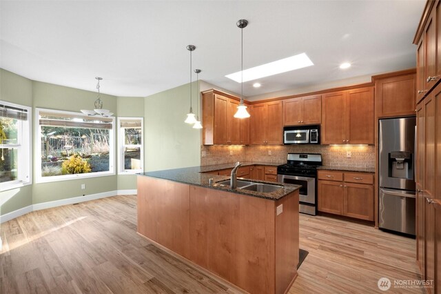 8148 Quinault Rd, Blaine, WA 98230 - kitchen with stainless steel appliances, a sink, brown cabinets, tasteful backsplash, and recessed lighting