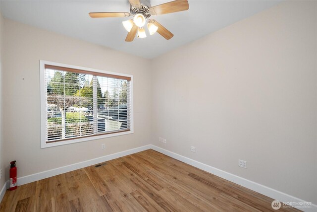 8148 Quinault Rd, Blaine, WA 98230 - empty room with baseboards, light wood-style flooring, and a ceiling fan