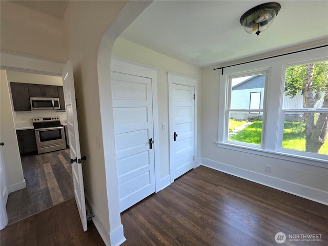 3839 S G St, Tacoma, WA 98418 - interior space with dark wood-style flooring, healthy amount of natural light, arched walkways, and baseboards