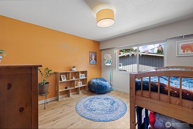8814 Earl Ave NW, Seattle, WA 98117 - bedroom featuring light wood-type flooring and a textured ceiling