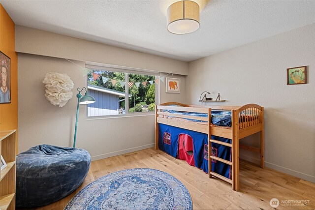 8814 Earl Ave NW, Seattle, WA 98117 - bedroom with wood finished floors and a textured ceiling