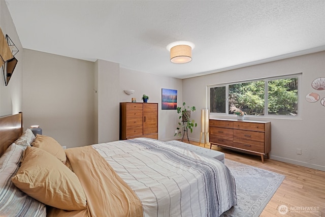 8814 Earl Ave NW, Seattle, WA 98117 - bedroom featuring light wood finished floors and a textured ceiling