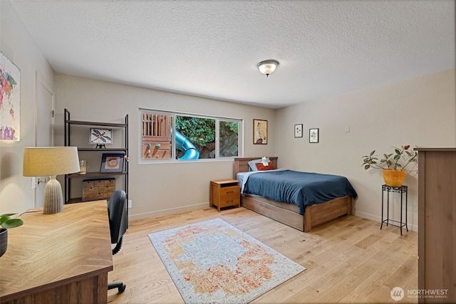 8814 Earl Ave NW, Seattle, WA 98117 - bedroom with wood finished floors and a textured ceiling