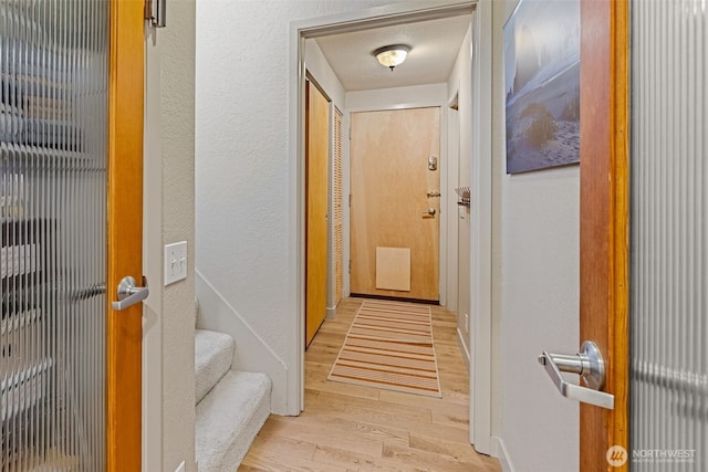 8814 Earl Ave NW, Seattle, WA 98117 - corridor with light wood-style floors and a textured wall