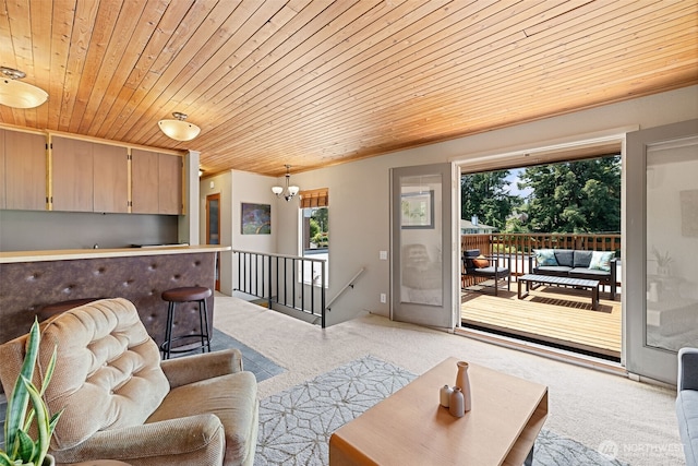 8814 Earl Ave NW, Seattle, WA 98117 - living room with wood ceiling, carpet, healthy amount of natural light, and a chandelier