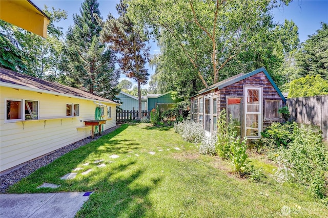 715 Grant St, Port Townsend, WA 98368 - fenced backyard featuring an exterior structure and an outbuilding