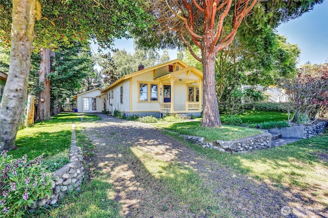 715 Grant St, Port Townsend, WA 98368 - view of front of property with a chimney, a front yard, and dirt driveway
