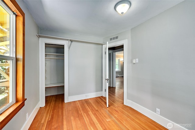 715 Grant St, Port Townsend, WA 98368 - unfurnished bedroom featuring light wood-style flooring, multiple windows, and a closet