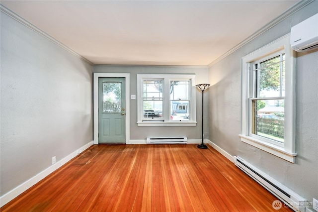 715 Grant St, Port Townsend, WA 98368 - foyer entrance featuring baseboard heating, a wall mounted air conditioner, light wood-style floors, and ornamental molding