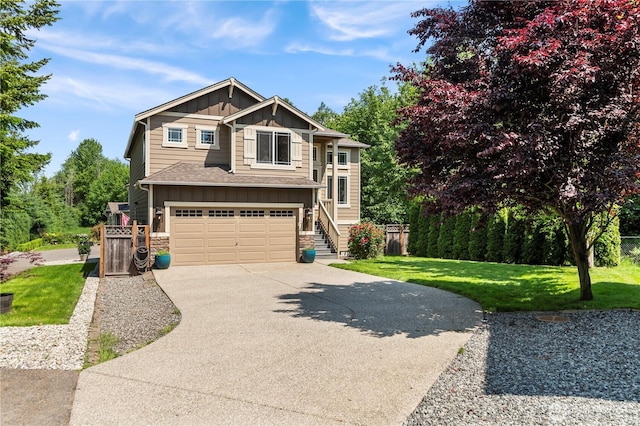 8305 172nd Pl NE, Arlington, WA 98223 - view of front of home featuring board and batten siding, stone siding, driveway, a garage, and roof with shingles