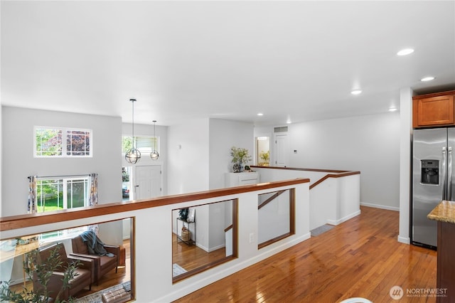 8305 172nd Pl NE, Arlington, WA 98223 - kitchen with stainless steel fridge, recessed lighting, light wood-style flooring, baseboards, and decorative light fixtures