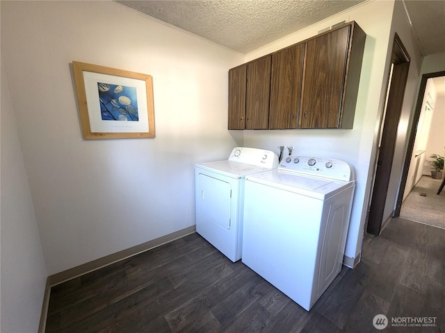 4608 73rd Street Ct E, Tacoma, WA 98443 - laundry room featuring cabinet space, washing machine and dryer, dark wood-style flooring, a textured ceiling, and baseboards