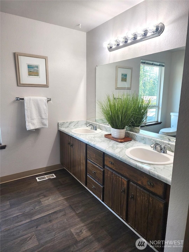 4608 73rd Street Ct E, Tacoma, WA 98443 - full bath with double vanity, wood finished floors, and toilet
