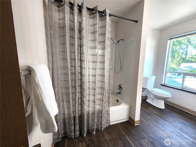 4608 73rd Street Ct E, Tacoma, WA 98443 - bathroom featuring toilet, wood finished floors, shower / bath combo with shower curtain, and baseboards