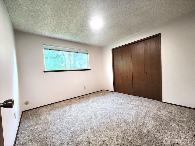 4608 73rd Street Ct E, Tacoma, WA 98443 - unfurnished bedroom featuring carpet flooring, a closet, a textured ceiling, and baseboards