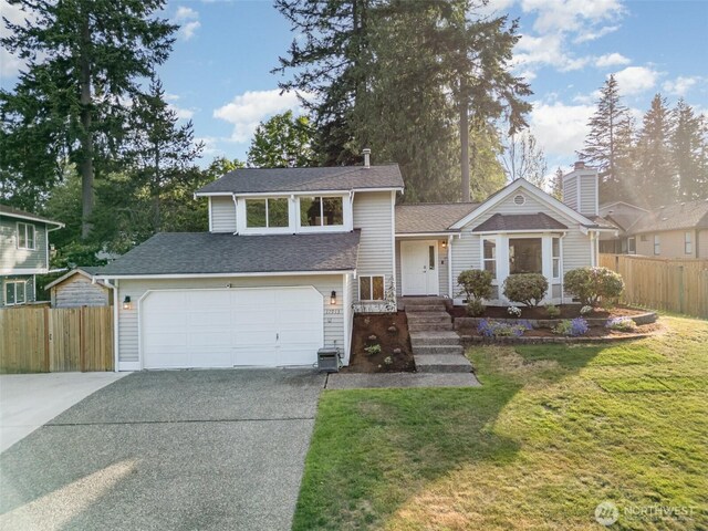 17913 158th Pl SE, Renton, WA 98058 - split level home with driveway, a garage, and a shingled roof