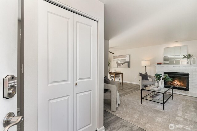 17913 158th Pl SE, Renton, WA 98058 - living room with wood finished floors, a brick fireplace, and baseboards