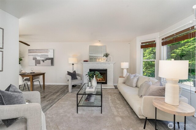 17913 158th Pl SE, Renton, WA 98058 - living area with healthy amount of natural light, wood finished floors, a fireplace, and baseboards