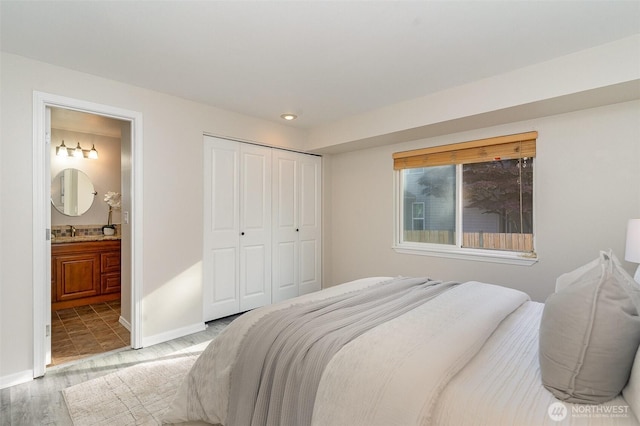 17913 158th Pl SE, Renton, WA 98058 - bedroom with a sink, a closet, baseboards, ensuite bathroom, and recessed lighting