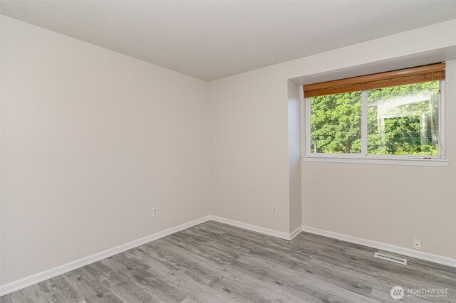 17913 158th Pl SE, Renton, WA 98058 - spare room featuring wood finished floors and baseboards