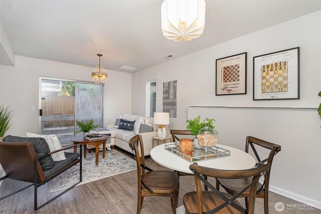 17913 158th Pl SE, Renton, WA 98058 - dining room featuring a chandelier, wood finished floors, and baseboards