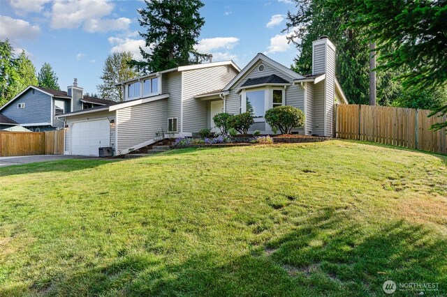 17913 158th Pl SE, Renton, WA 98058 - view of front of home featuring an attached garage, driveway, and a chimney