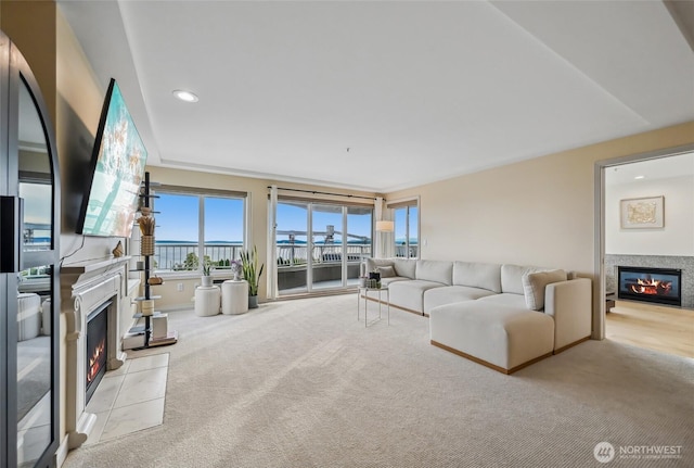 601 W Mercer Pl Unit 201, Seattle, WA 98119 - living area featuring a glass covered fireplace, light carpet, and recessed lighting