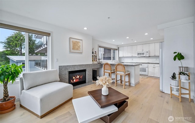 601 W Mercer Pl Unit 201, Seattle, WA 98119 - living room with a glass covered fireplace, light wood-type flooring, and recessed lighting