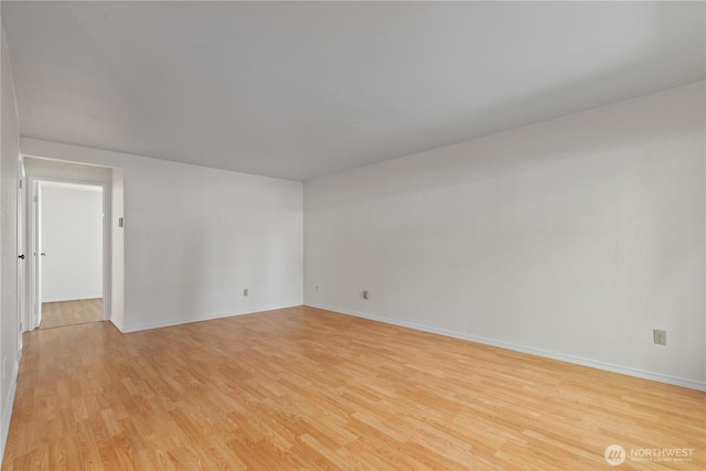 7520 208th St SW Unit A104, Edmonds, WA 98026 - spare room featuring light wood finished floors and baseboards