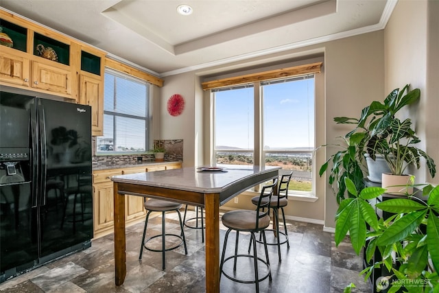 411 Terrett Way, Yakima, WA 98901 - dining area with a tray ceiling, healthy amount of natural light, baseboards, dark stone finish floors, and crown molding