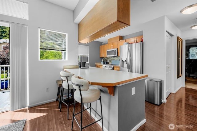 21230 40th Way S Unit D, Seatac, WA 98198 - kitchen with appliances with stainless steel finishes, plenty of natural light, and dark wood finished floors