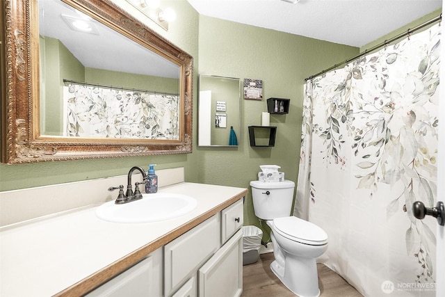 1226 Juniper Dr SE, Olympia, WA 98513 - full bath featuring a textured wall, vanity, and wood finished floors