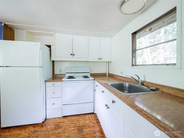 9712 Channel Dr NW, Olympia, WA 98502 - kitchen with white appliances, a sink, white cabinetry, and light wood-type flooring